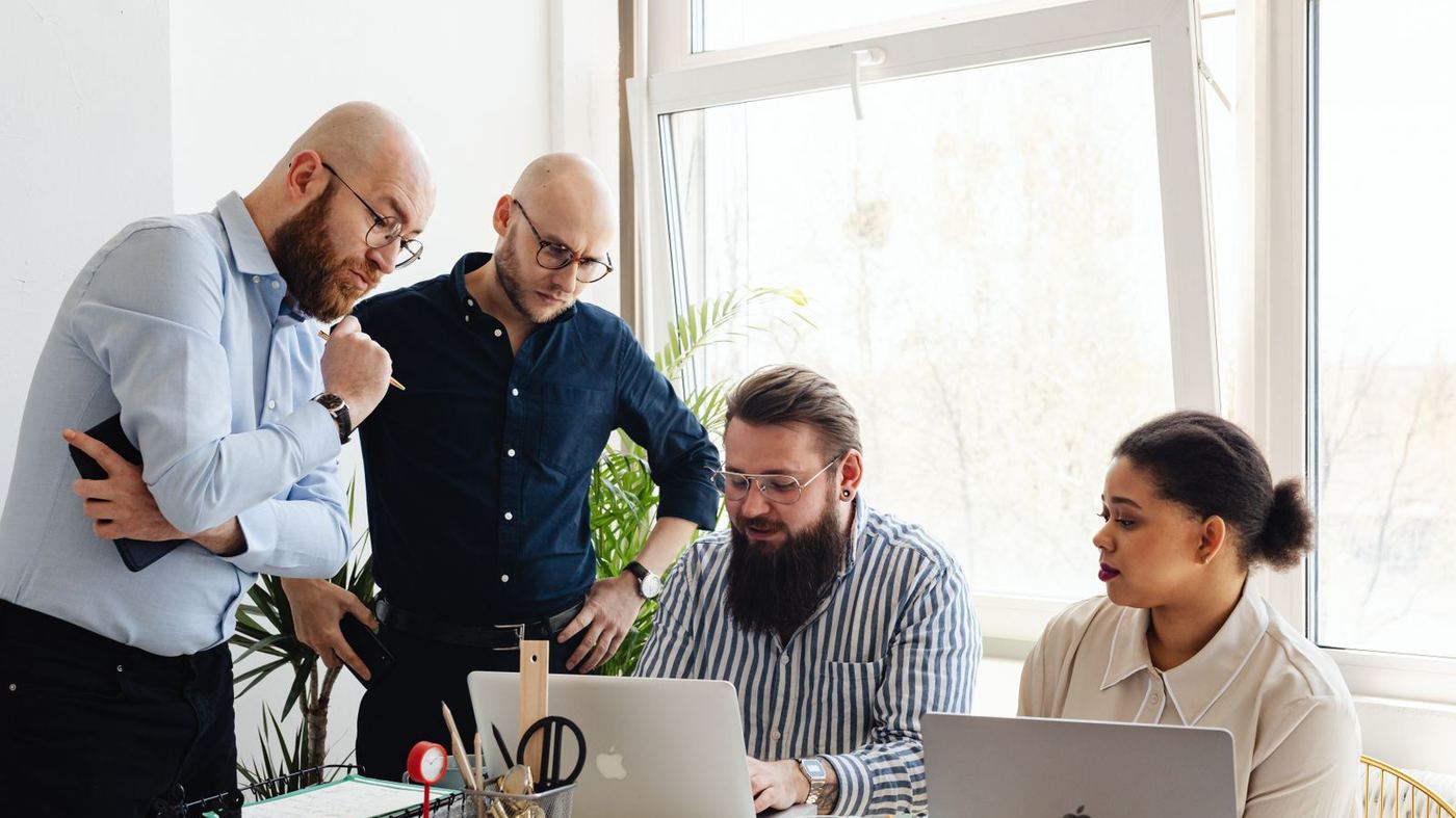 A small team around two laptops, the kind of specific buyer a narrower question is written for